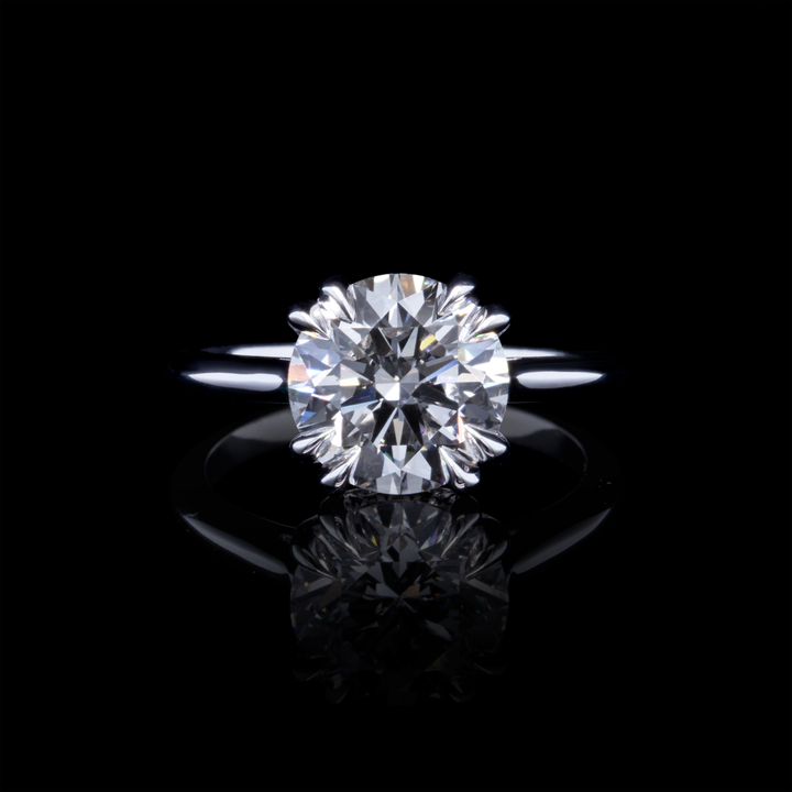 EOS platinum engagement ring with 3ct round brilliant lab-grown diamond, dramatic black background shot.