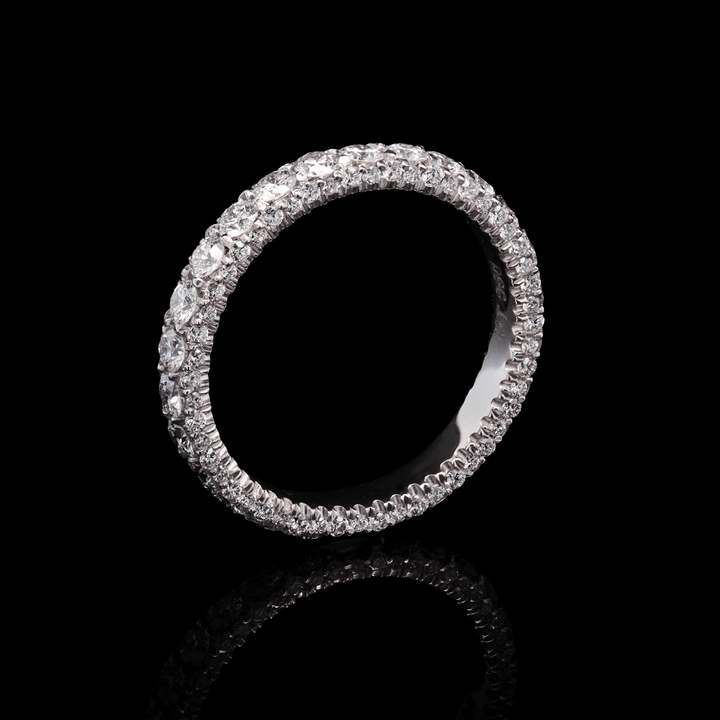 Three-sided platinum band adorned with lab-grown diamonds. (Stardust Eternity Ring). Shown on black background.