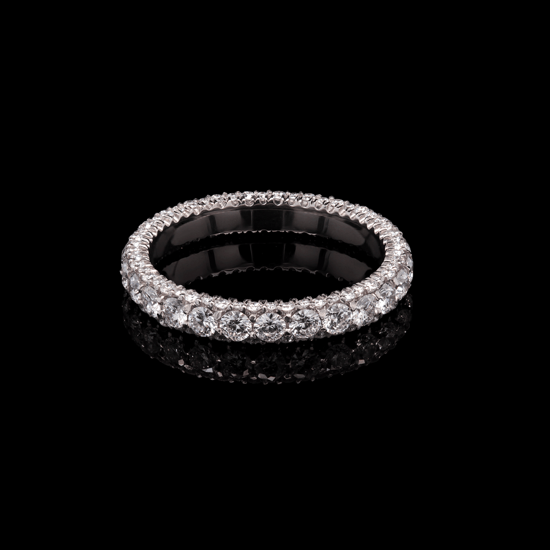 Three-sided platinum band adorned with lab-grown diamonds. Shown on a black background.