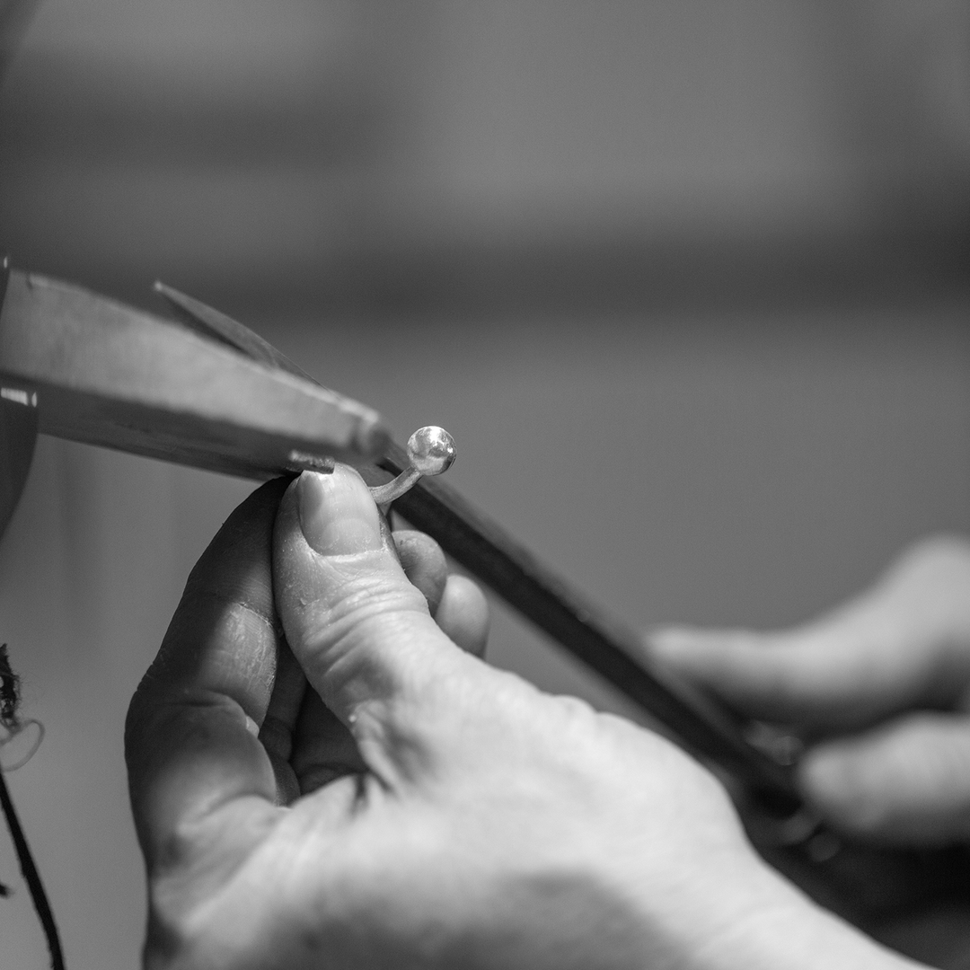 Sabrina Melendez, teaching a platinum fundamentals course. cleaning a platinum cuff-link at her bench.