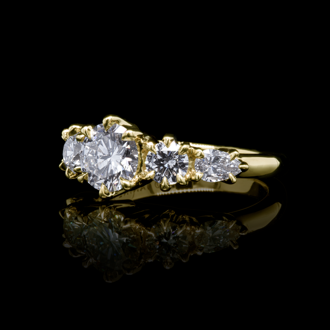 Side view of Aurea Ring showcasing the sculptural gold band and diamond setting, fine jewellery by Janine Jewels on black background
