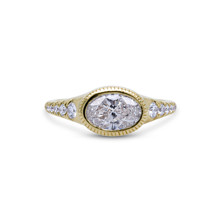 Side angle of oval diamond ring in 18K yellow gold with pavé side stones, fine engagement jewellery by Janine Jewels.