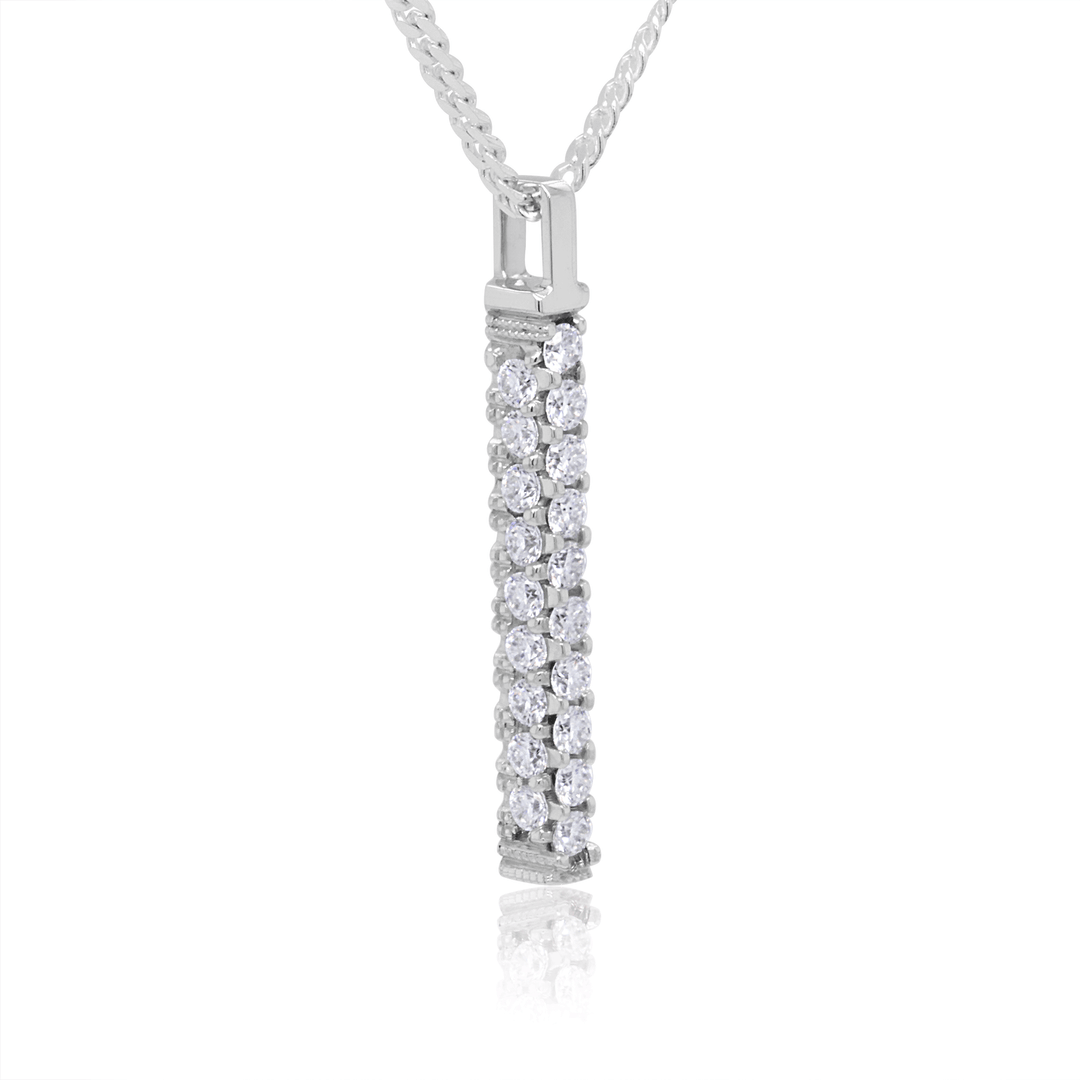 Twenty-eight round moissanite stones pave-set in a three-sided platinum bar pendant, suspended on a sleek flat silver Cuban link chain. (White background). Side View