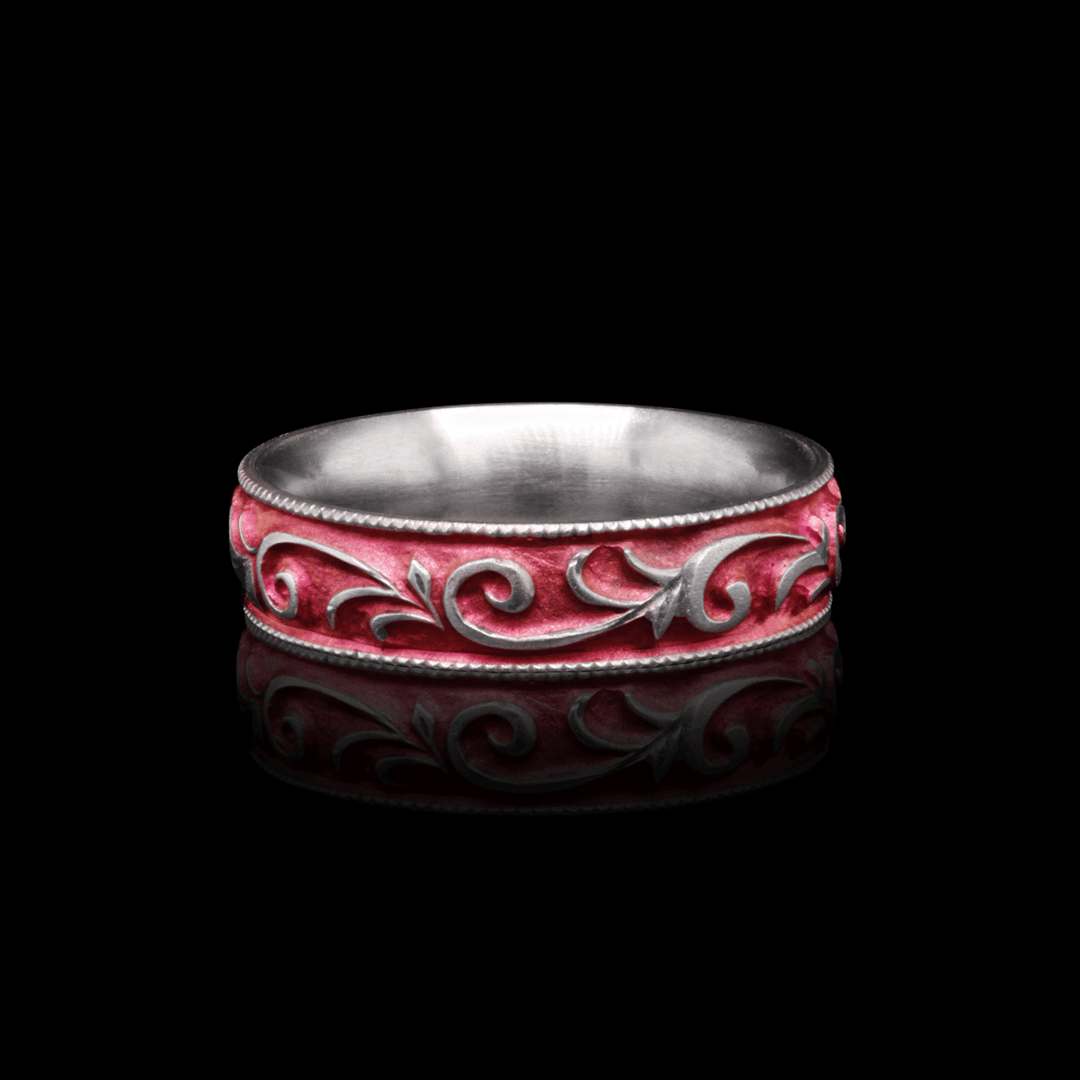 5mm blush pink titanium ring with vine-inspired engraving, highlighted against a black background for contrast, size 6.5.
