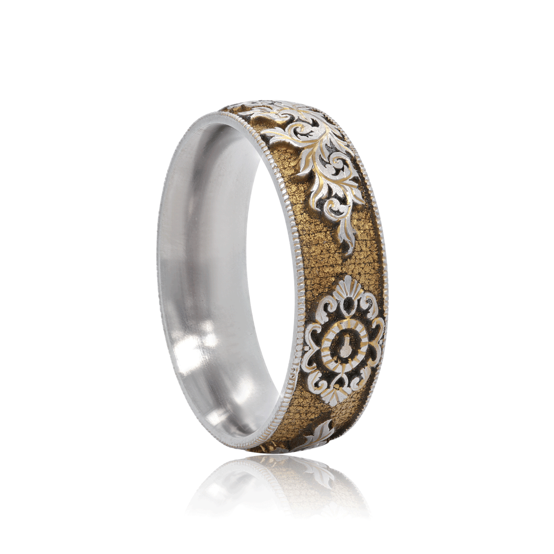 Side view of Gilded Gate titanium ring, showcasing gold anodized finish with hand-engraved lock and key motif, on a white background.