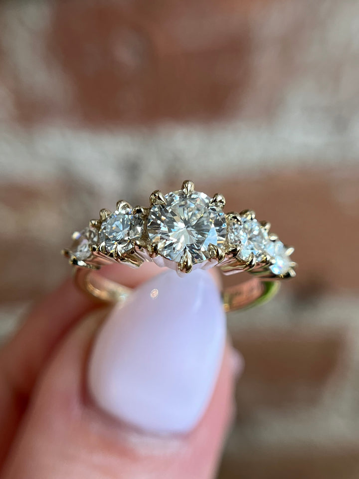 Artistic photo of Aurea engagement ring, diamond in yellow gold with dramatic light and shadow