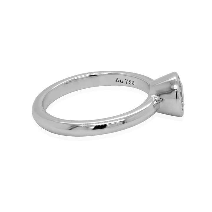 Elegant solitaire ring with a moissanite center stone. The ring is crafted from 18K white gold and offers a timeless design.