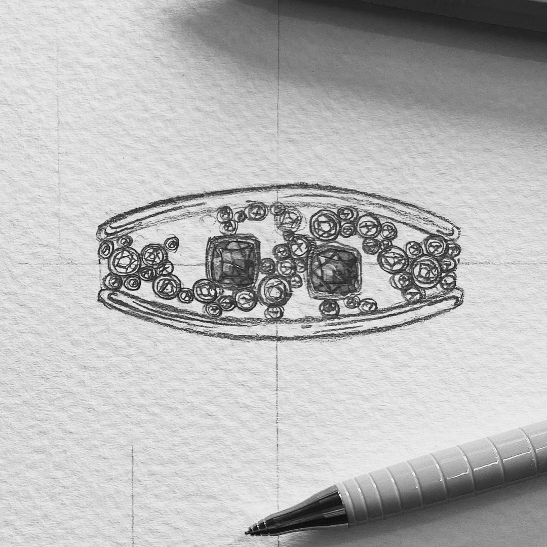sketch made during a jewellery design course. Sketch of a white gold bangle with 2 rubies that are bezel-set and bezel-set accent diamonds around.