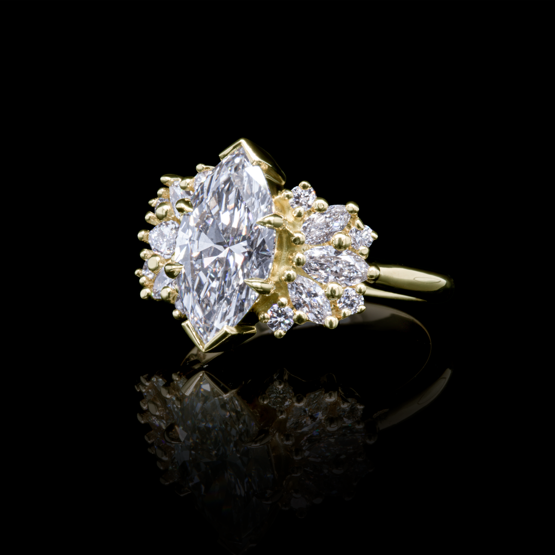 Clara engagement ring in recycled yellow gold featuring a marquise lab diamond with 2.65ct total diamond weight, black background