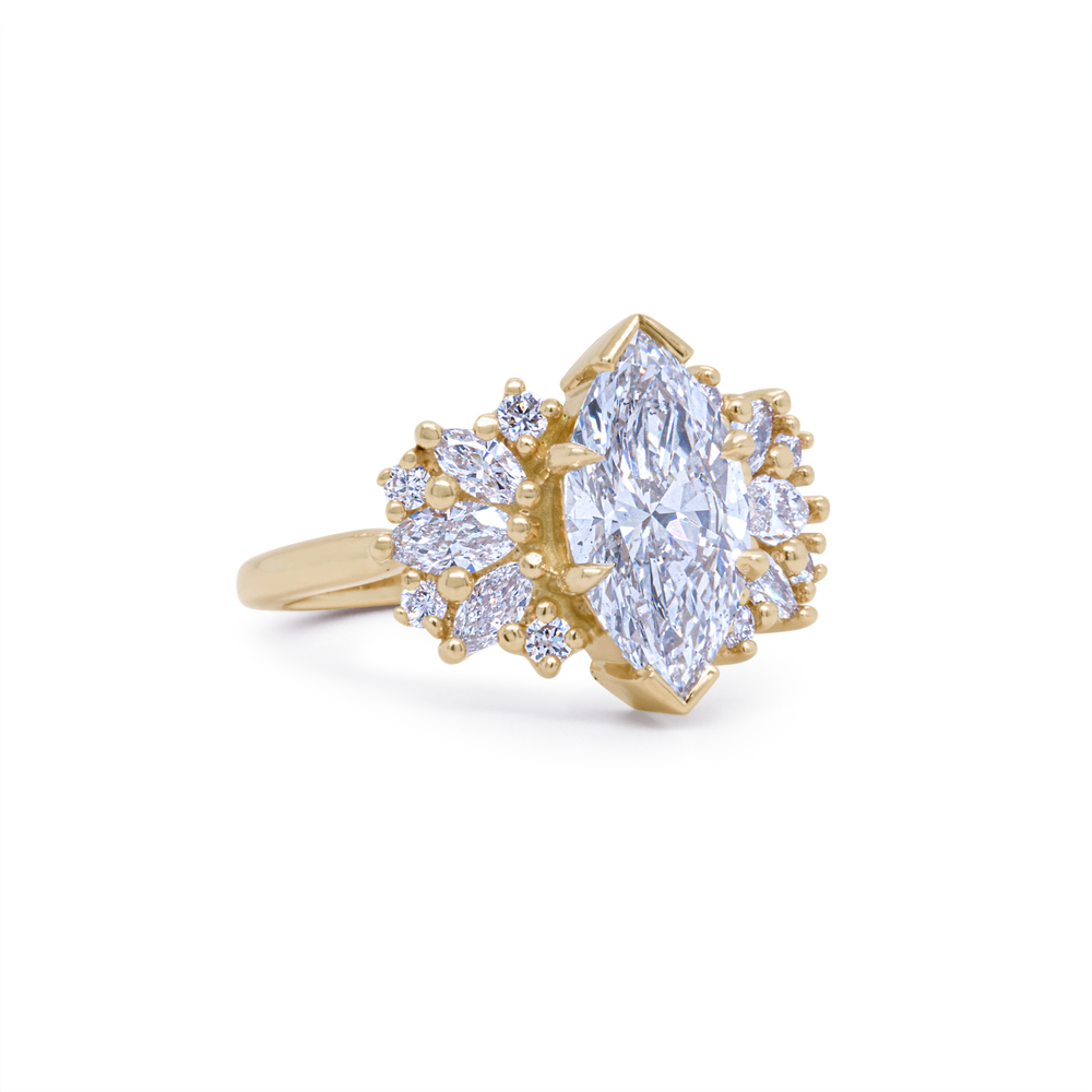 Side angle of Clara marquise lab diamond ring in recycled yellow gold with flowing accent stones, handcrafted by Janine Jewels.