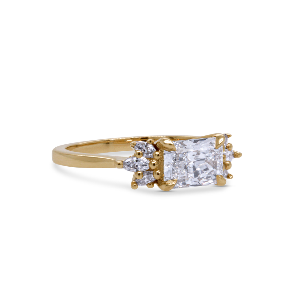 Side angle of radiant cut diamond engagement ring in recycled yellow gold with accent diamonds, fine jewellery Toronto.