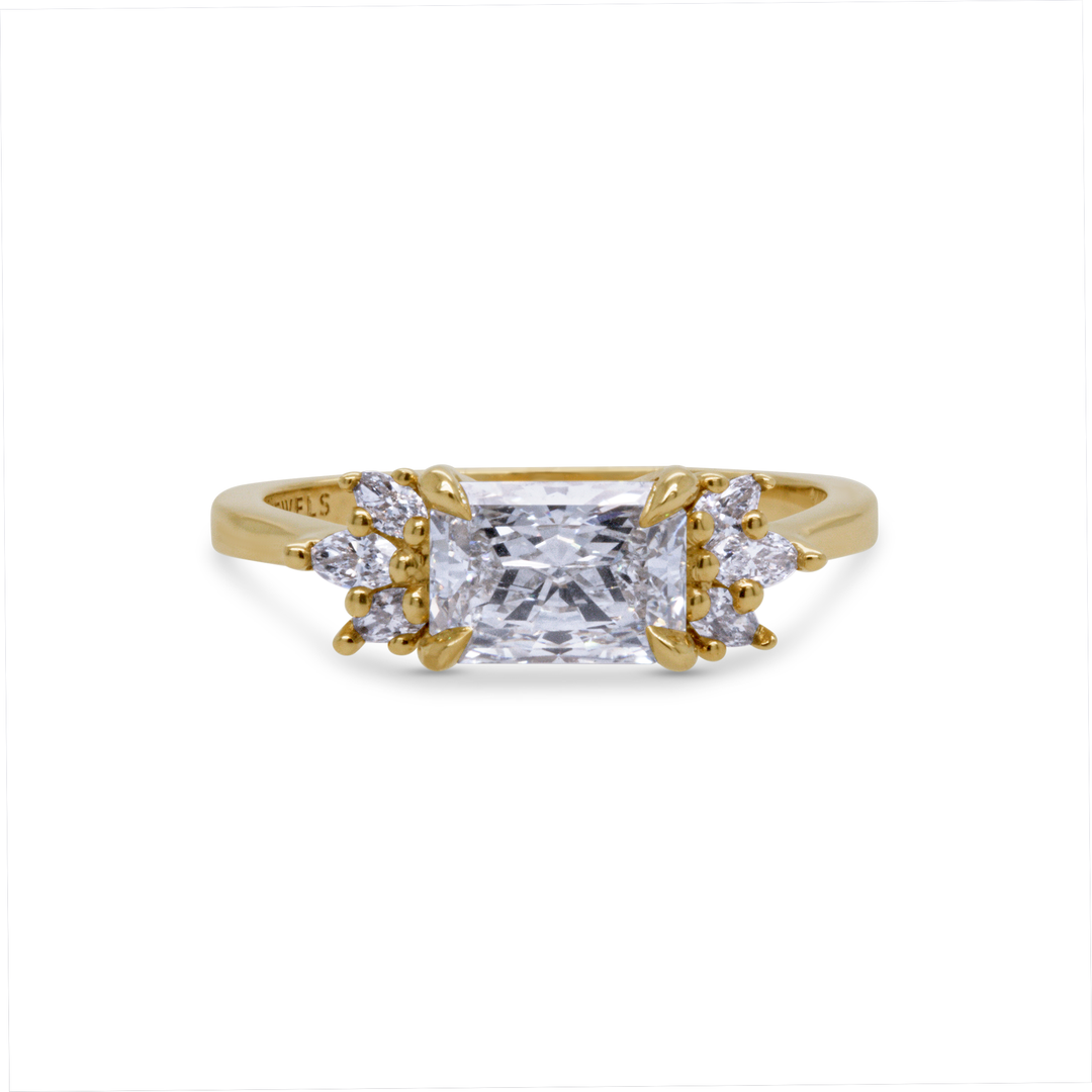 Radiant cut lab diamond engagement ring in 14K yellow gold with marquise and round side stones, handcrafted by Janine Jewels Toronto.