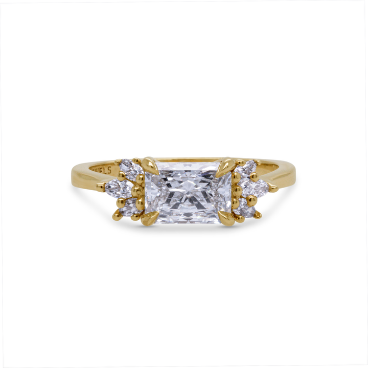 Radiant cut lab diamond engagement ring in 14K yellow gold with marquise and round side stones, handcrafted by Janine Jewels Toronto.