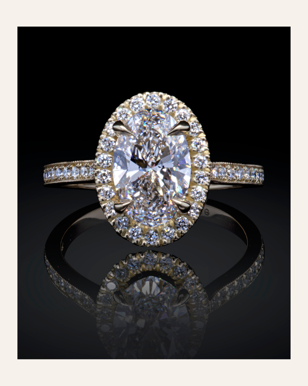 Lab-grown diamond ring with a large oval-shaped diamond center stone and diamond halo with diamond-set shank on a black background