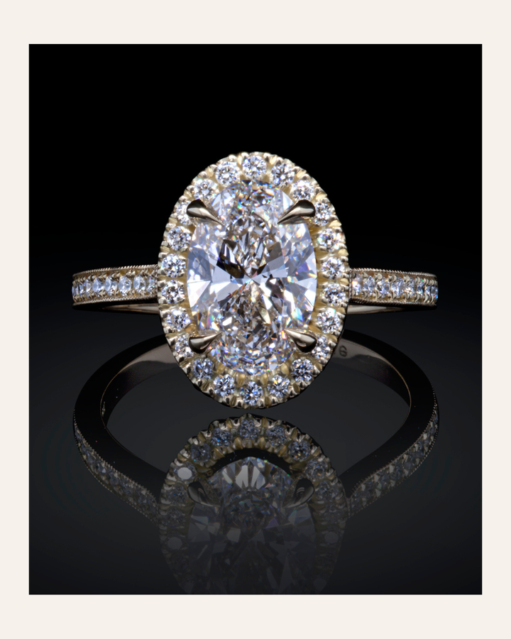 Lab-grown diamond ring with a large oval-shaped diamond center stone and diamond halo with diamond-set shank on a black background