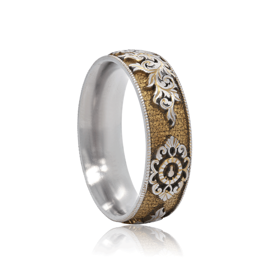 Side view of Gilded Gate titanium ring, showcasing gold anodized finish with hand-engraved lock and key motif, on a white background.