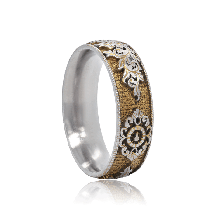 Side view of Gilded Gate titanium ring, showcasing gold anodized finish with hand-engraved lock and key motif, on a white background.