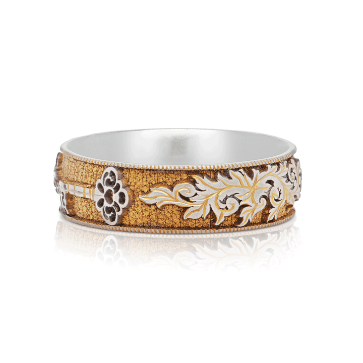 Shot of Gilded Gate titanium ring, highlighting gold anodized finish and symbolic key design, displayed on a white background.