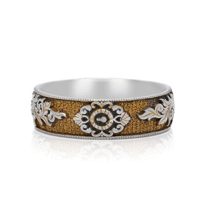 Front view of Gilded Gate titanium ring, showcasing gold anodized finish with hand-engraved lock and key motif, on a white background.