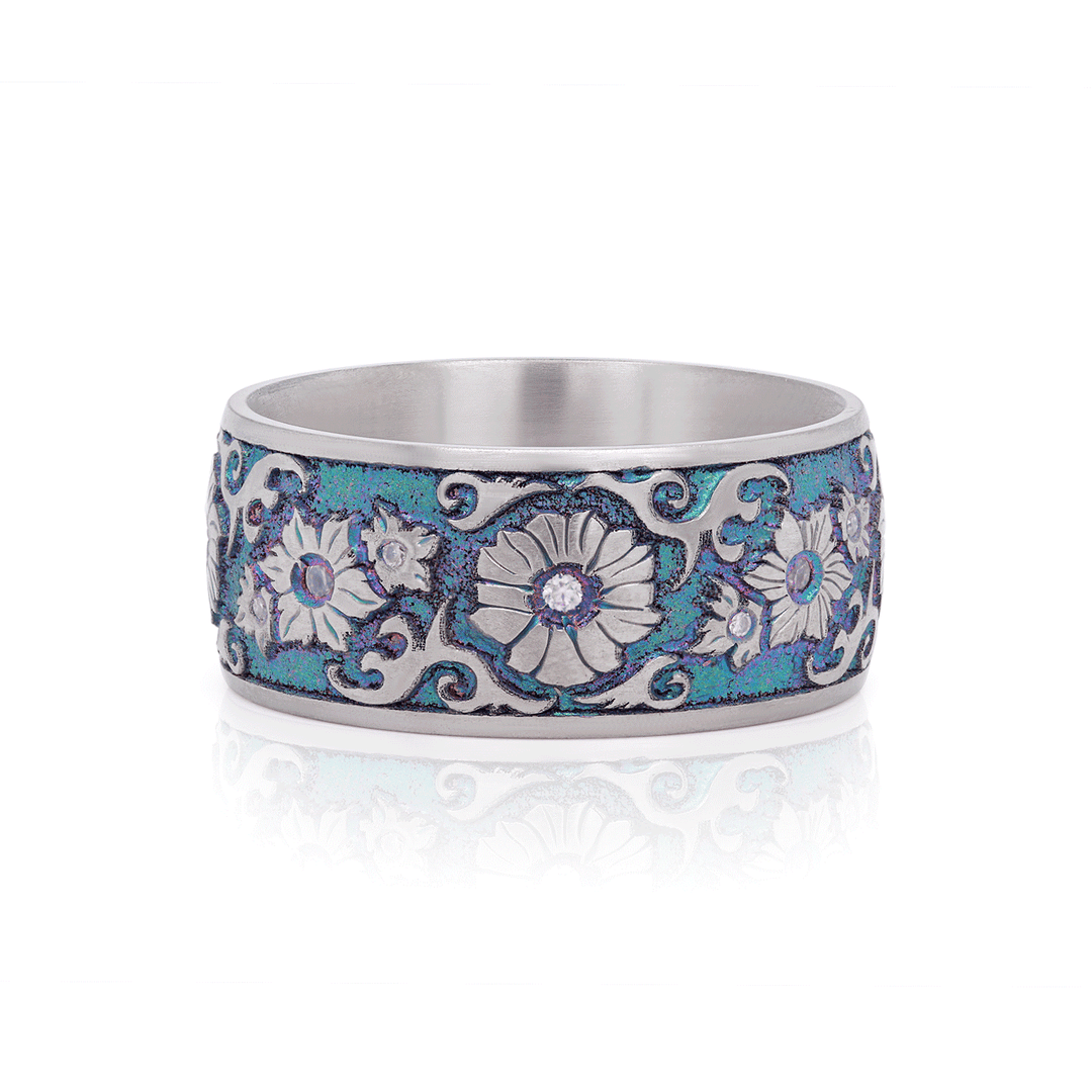 10mm titanium ring with iridescent floral engraving, featuring four 1.4mm and eight 1.0mm bezel-set white moissanite stones, displayed on a white background.