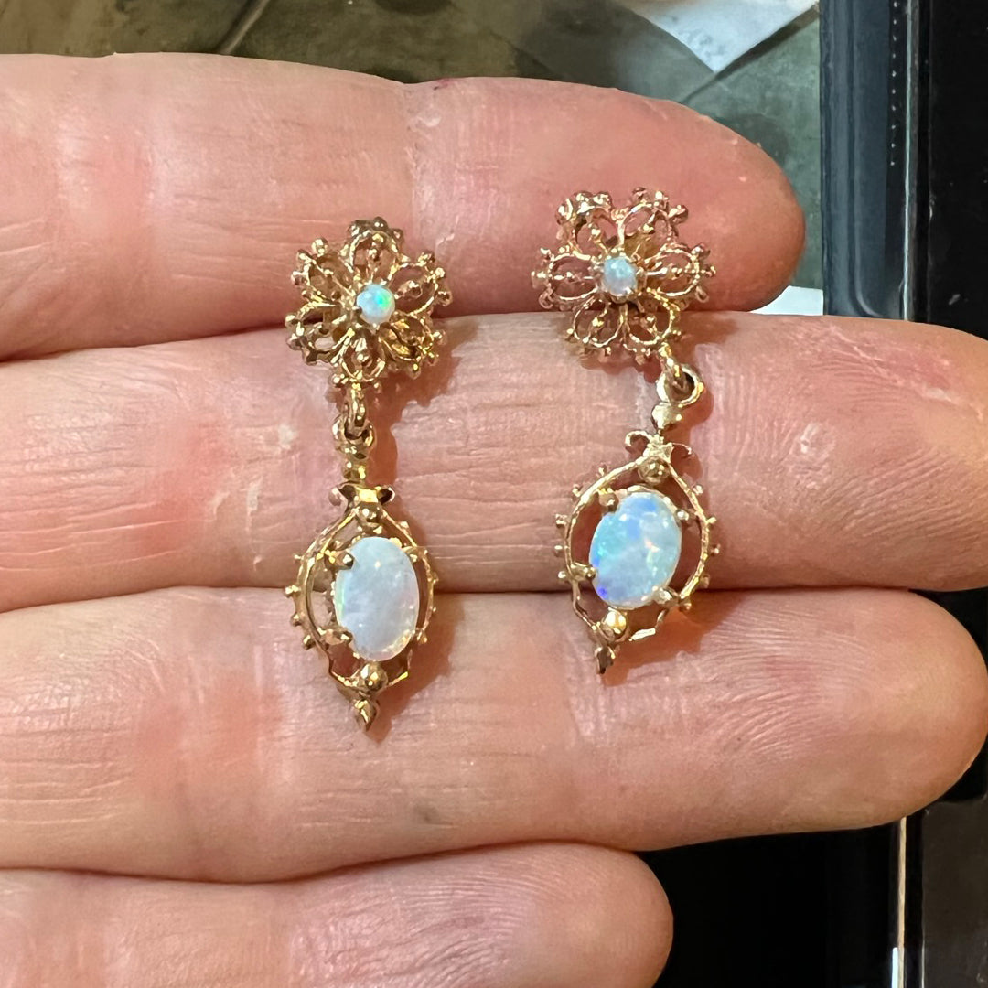 Vintage yellow gold earrings with opals and gold filigree details. Earrings are being checked and getting ready for appraisal